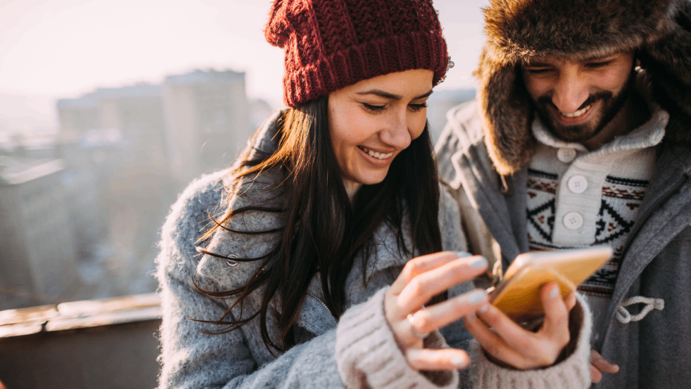 A young couple exchanging phone numbers