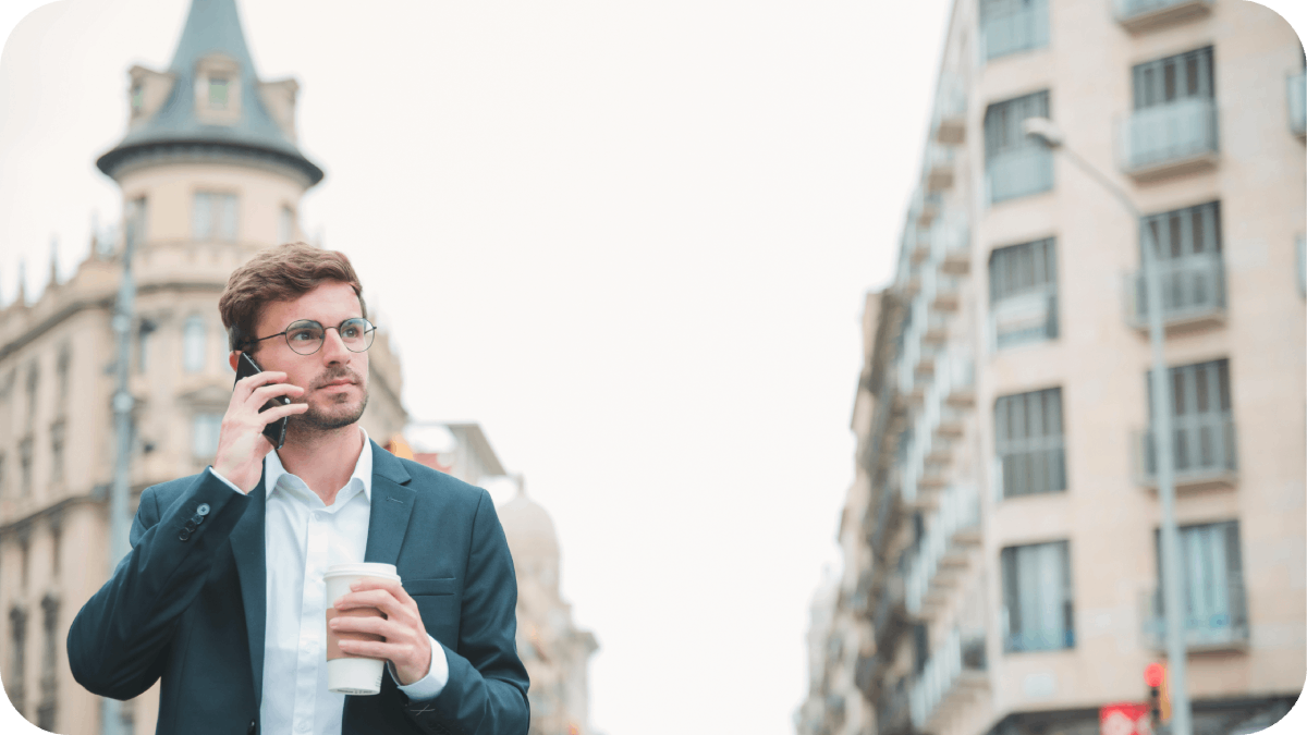 a businessman holding standing street of USA holding takeaway coffee cup hand calling someone to Greece