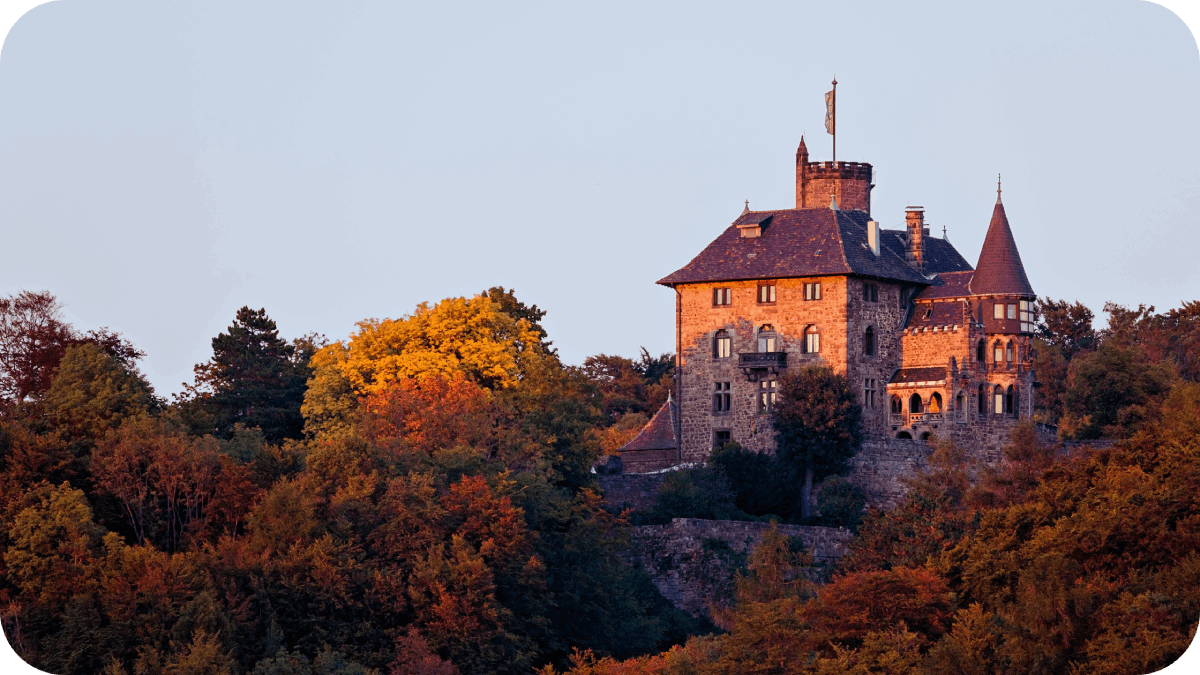 view of Schloss Berlepsch which is surrounded by autumn trees 