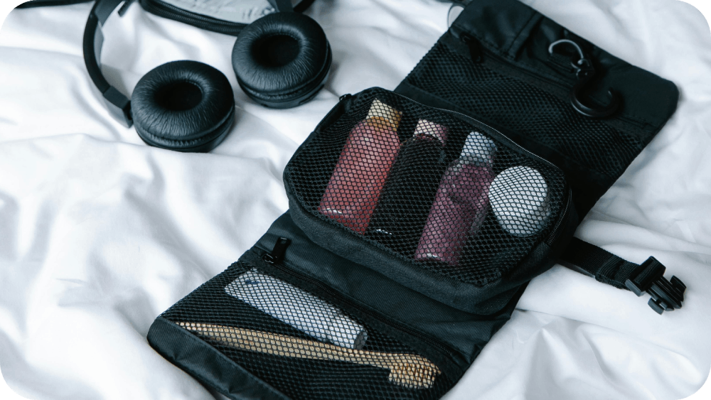 Black Headphones Beside Bag with Toiletries