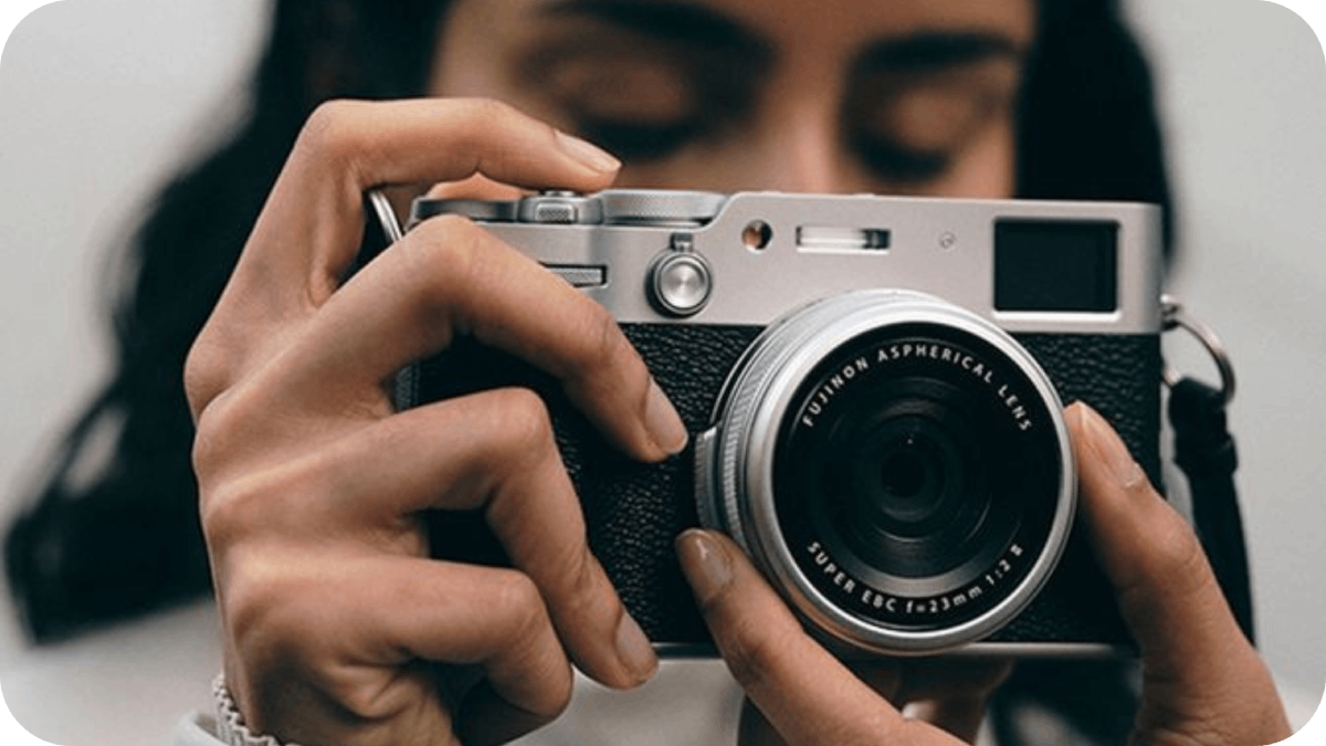 a women holding a fuji camera