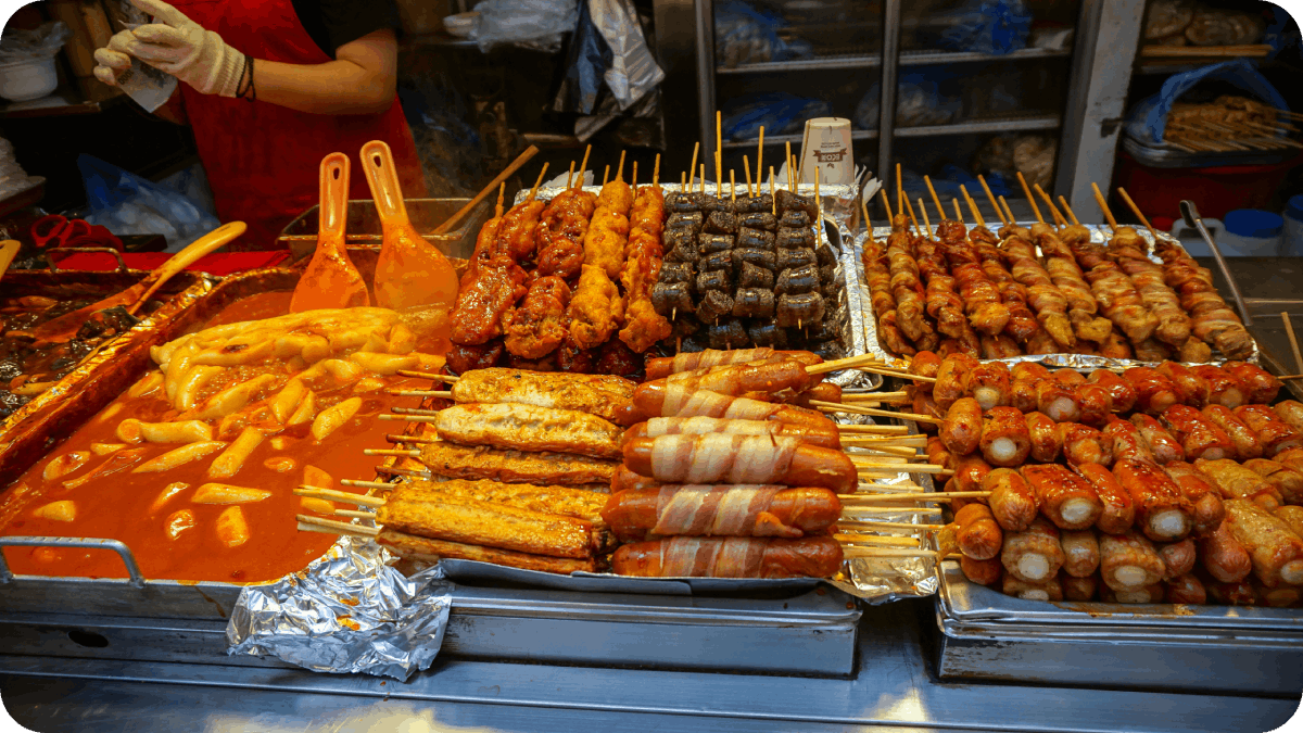 Korean street food with skewers and spicy tteokbokki, a must-try for food lovers.